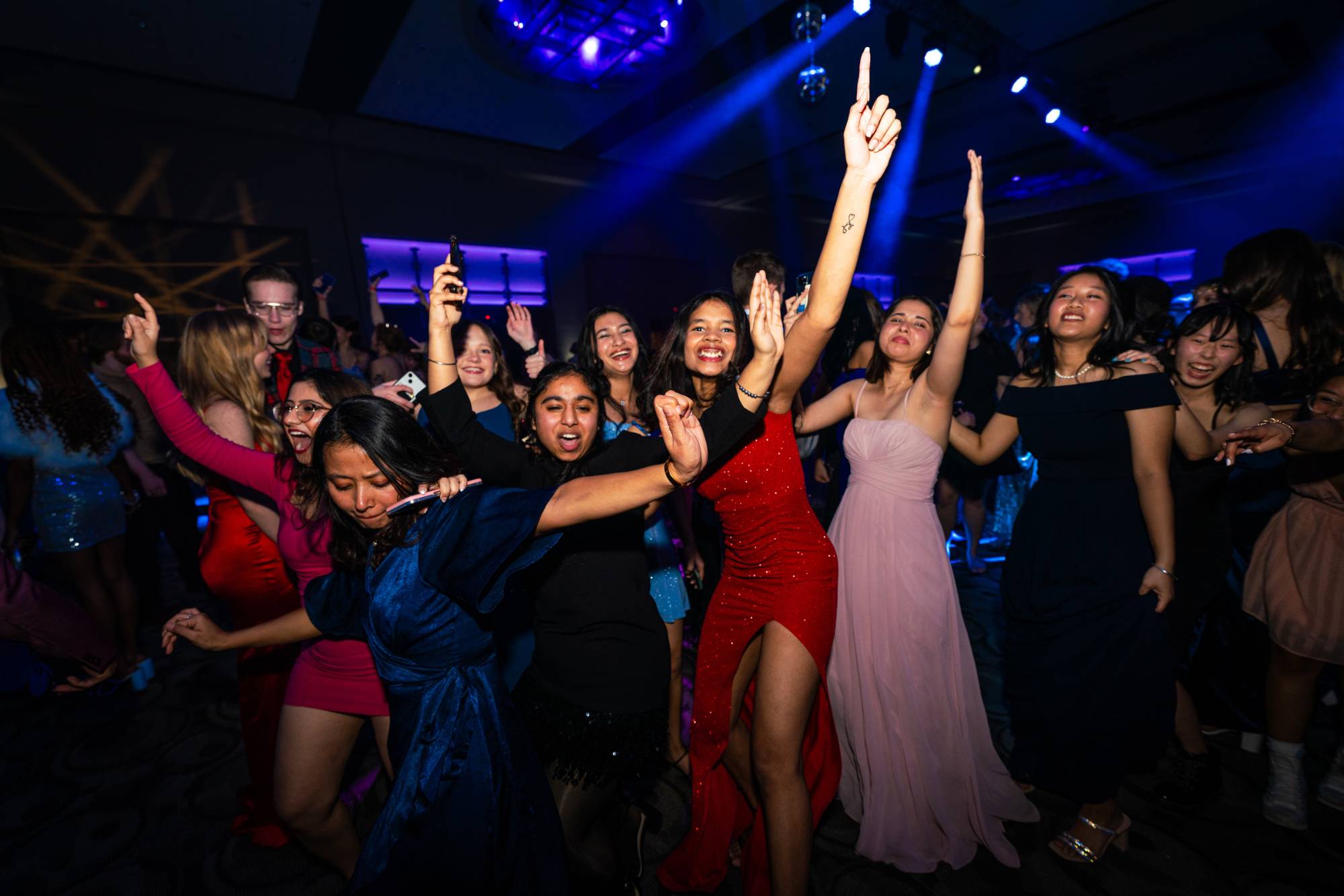 Students smiling and dancing at Presidents' Ball